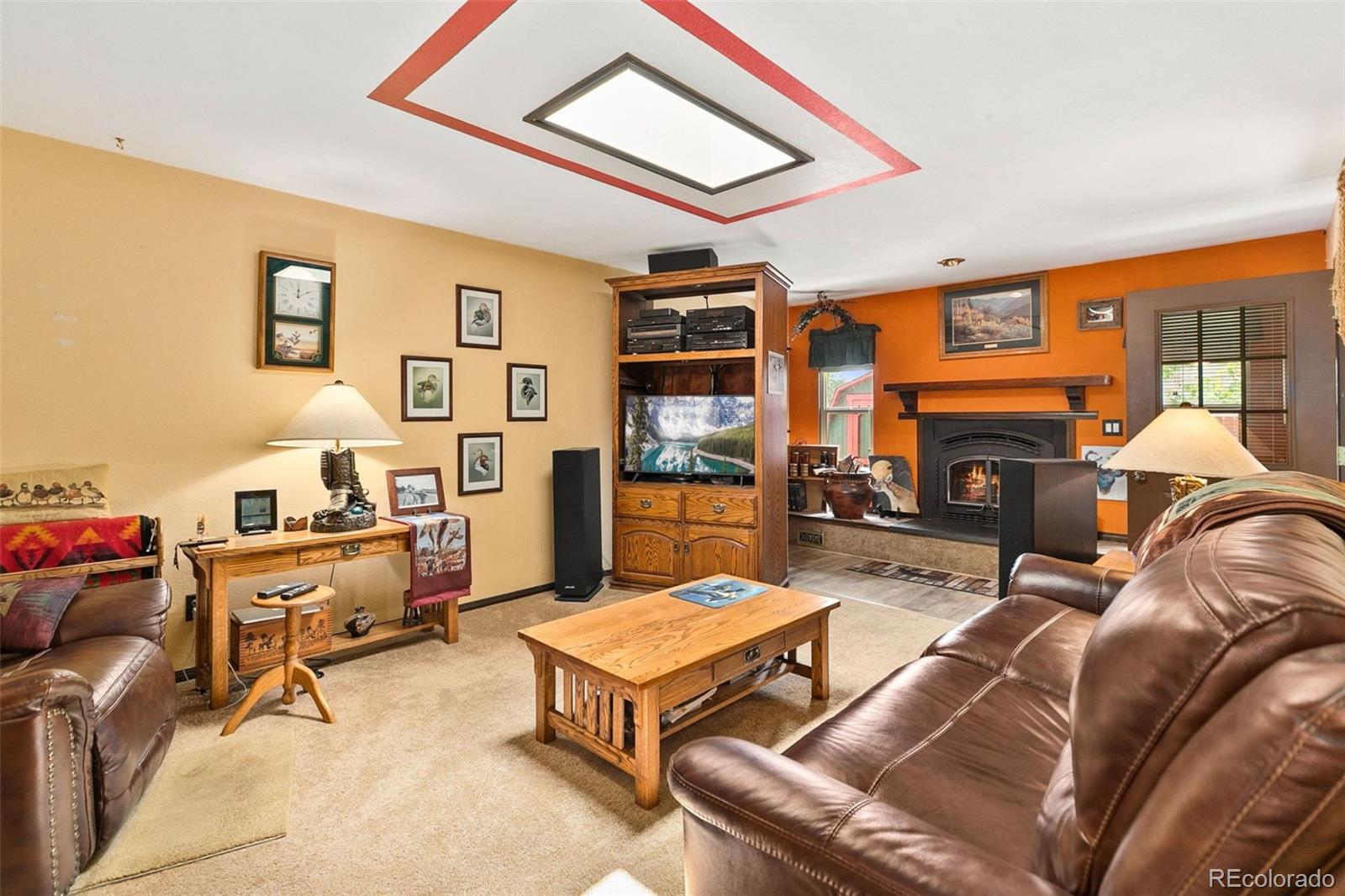 13 Maple Drive Frederick, CO 80530 - Photo 2 of 32 a living room with furniture a fireplace and a large window
