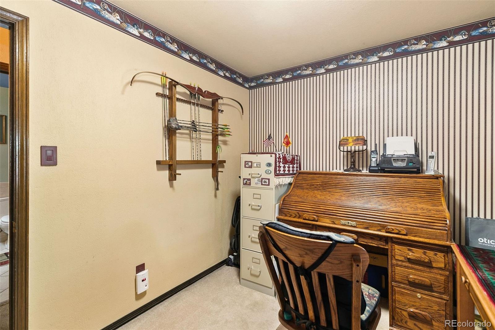 13 Maple Drive Frederick, CO 80530 - Photo 21 of 32 a bedroom with a bed and wooden floor