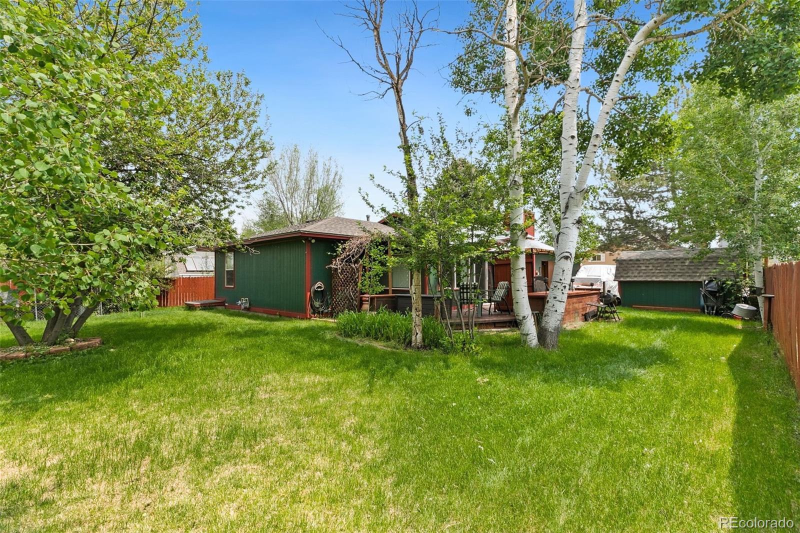 13 Maple Drive Frederick, CO 80530 - Photo 31 of 32 a view of a house with a yard and a tree