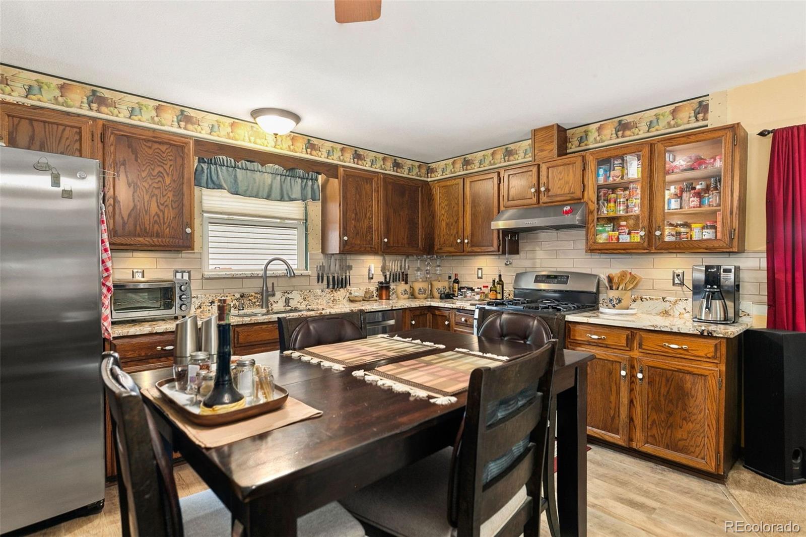 13 Maple Drive Frederick, CO 80530 - Photo 6 of 32 a kitchen with a sink a stove and chairs