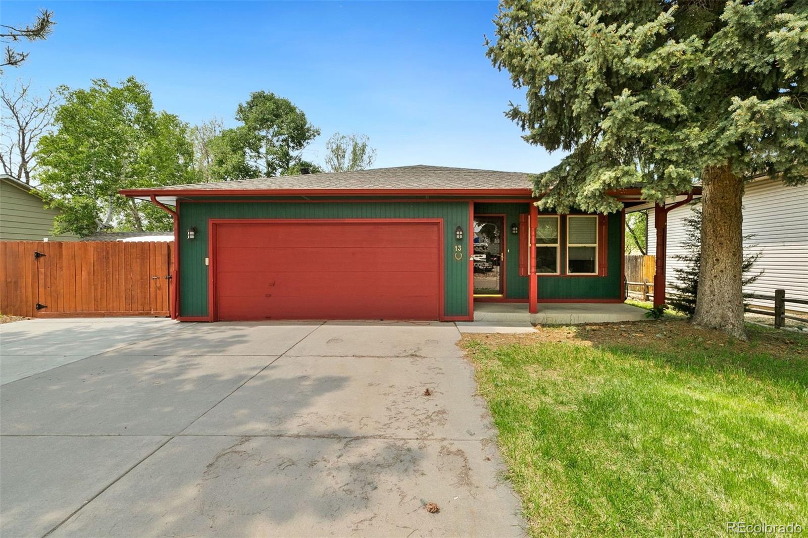 13 Maple Drive Frederick, CO 80530 - Photo 7 of 32 a front view of a house with a yard and garage