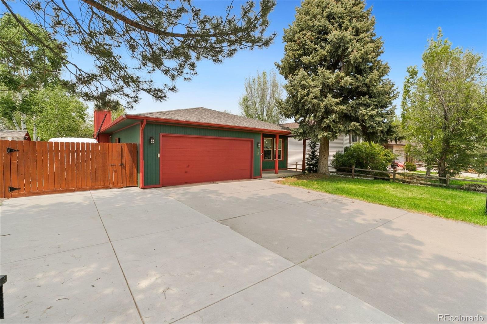 13 Maple Drive Frederick, CO 80530 - Photo 8 of 32 a front view of a house with a yard and garage