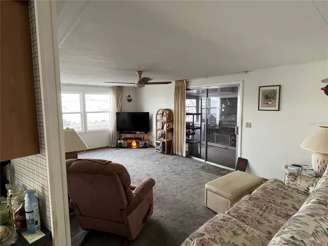 a bedroom with a bed and a refrigerator