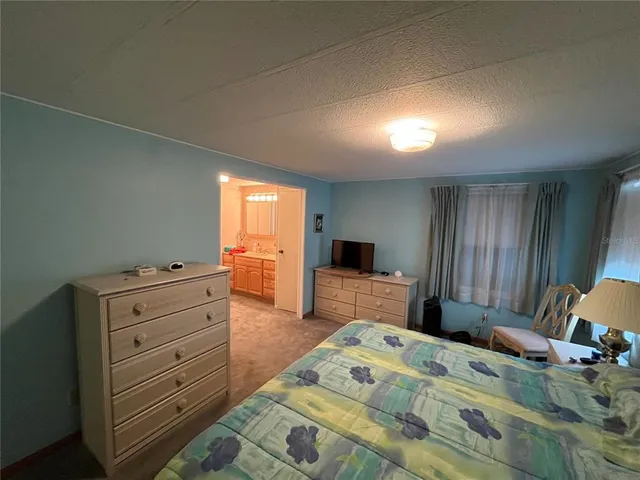 a bedroom that has a bed and a desk in it
