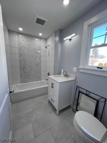 a bathroom with a double vanity sink toilet and shower