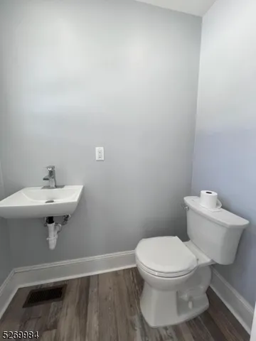 a white toilet sitting next to a white sink