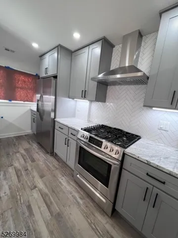 a kitchen with stainless steel appliances granite countertop a stove and a refrigerator