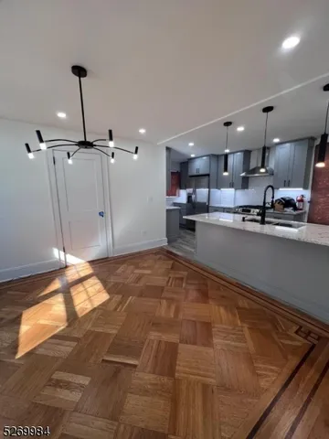 a large kitchen with kitchen island a sink stainless steel appliances and a counter top