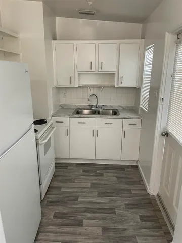 a kitchen with a sink cabinets and appliances