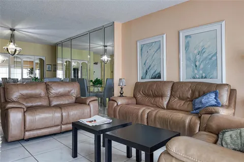 a living room with furniture and a painting on the wall