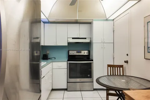 a kitchen with stainless steel appliances a stove a sink and a refrigerator