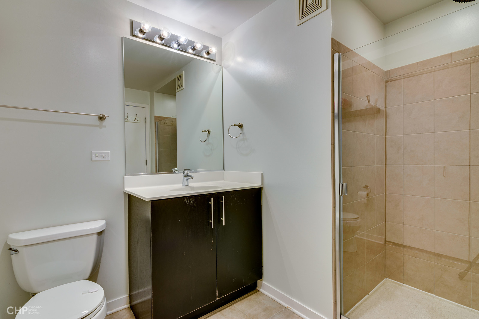 611 South Wells Street, Unit 2907 Chicago, IL 60607 - Photo 11 of 16 a bathroom with a sink a toilet and shower