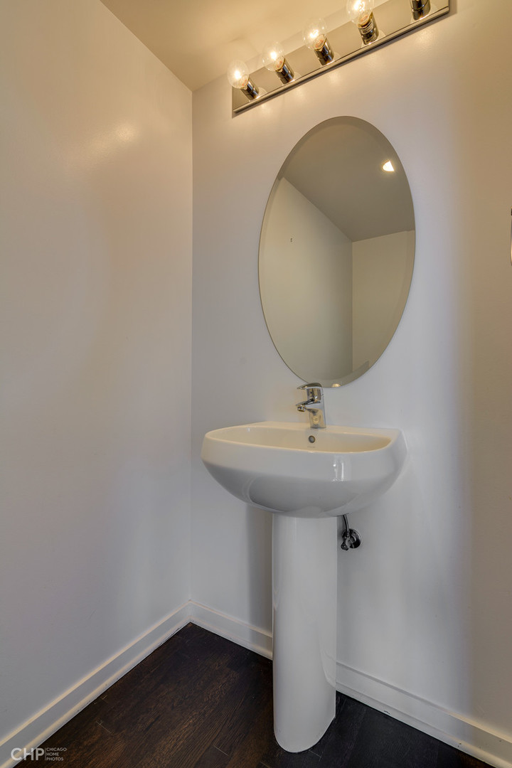 611 South Wells Street, Unit 2907 Chicago, IL 60607 - Photo 14 of 16 a bathroom with a sink a mirror and vanity