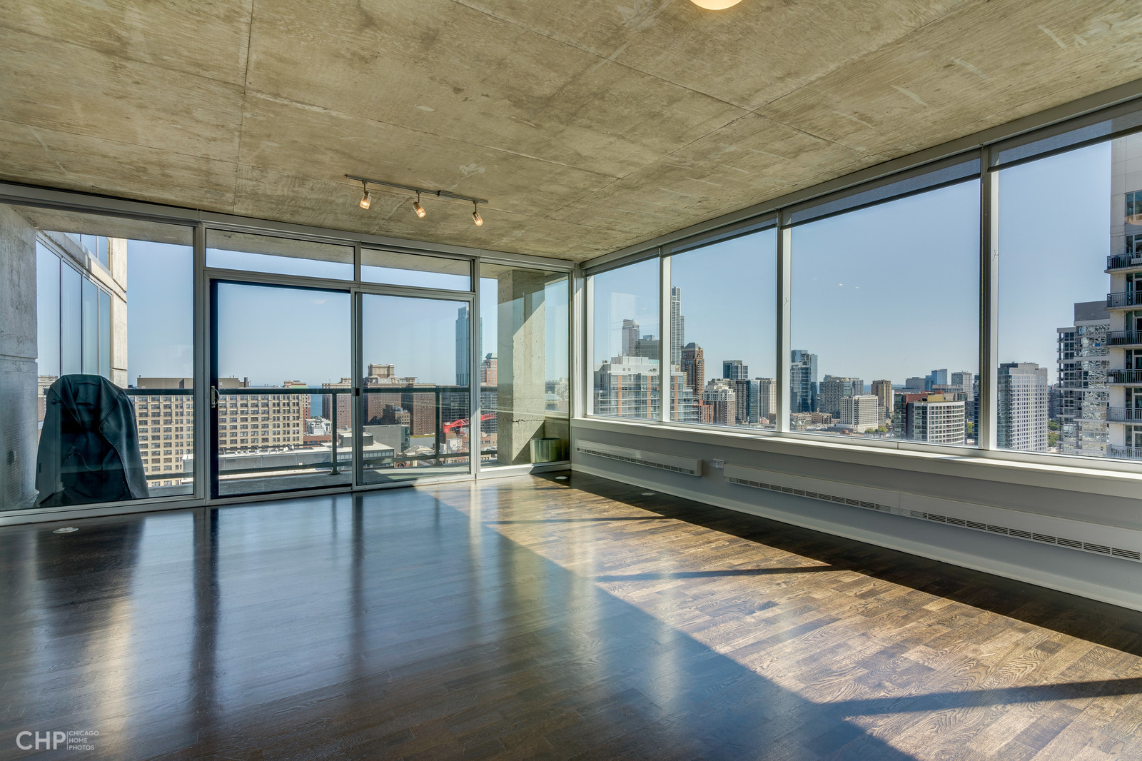 611 South Wells Street, Unit 2907 Chicago, IL 60607 - Photo 2 of 16 a view of an empty room with wooden floor and a window