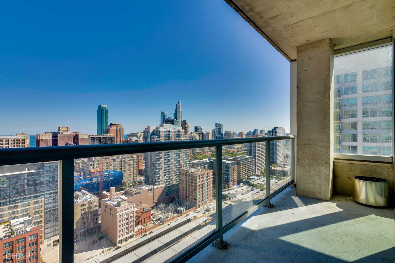611 South Wells Street, Unit 2907 Chicago, IL 60607 - Photo 3 of 16 a view of a balcony with two chairs and a table