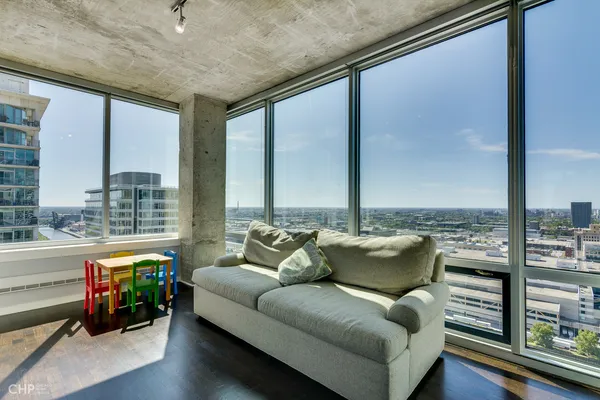 a bed sitting in a spacious bedroom next to a window