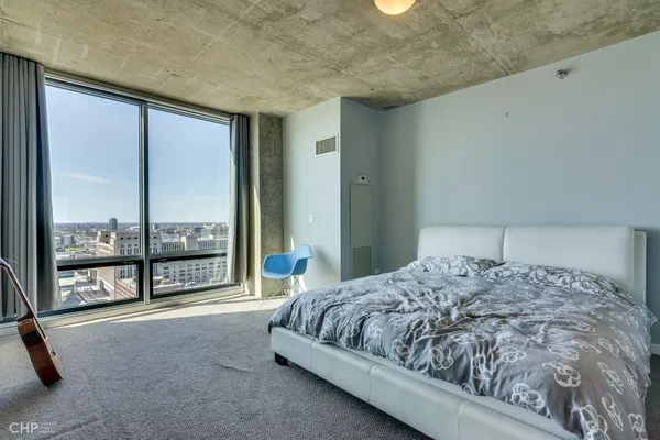 a bedroom with a bed and a chair