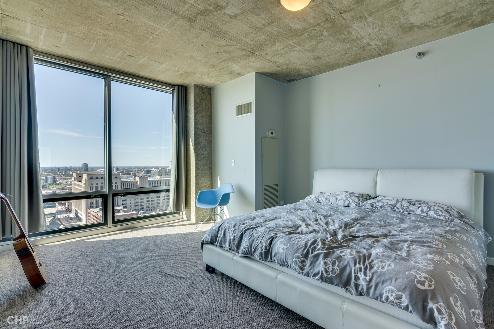 611 South Wells Street, Unit 2907 Chicago, IL 60607 - Photo 8 of 16 a bed sitting in a spacious bedroom next to a window