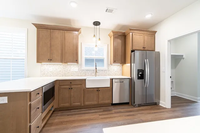 a large kitchen with a large window and stainless steel appliances