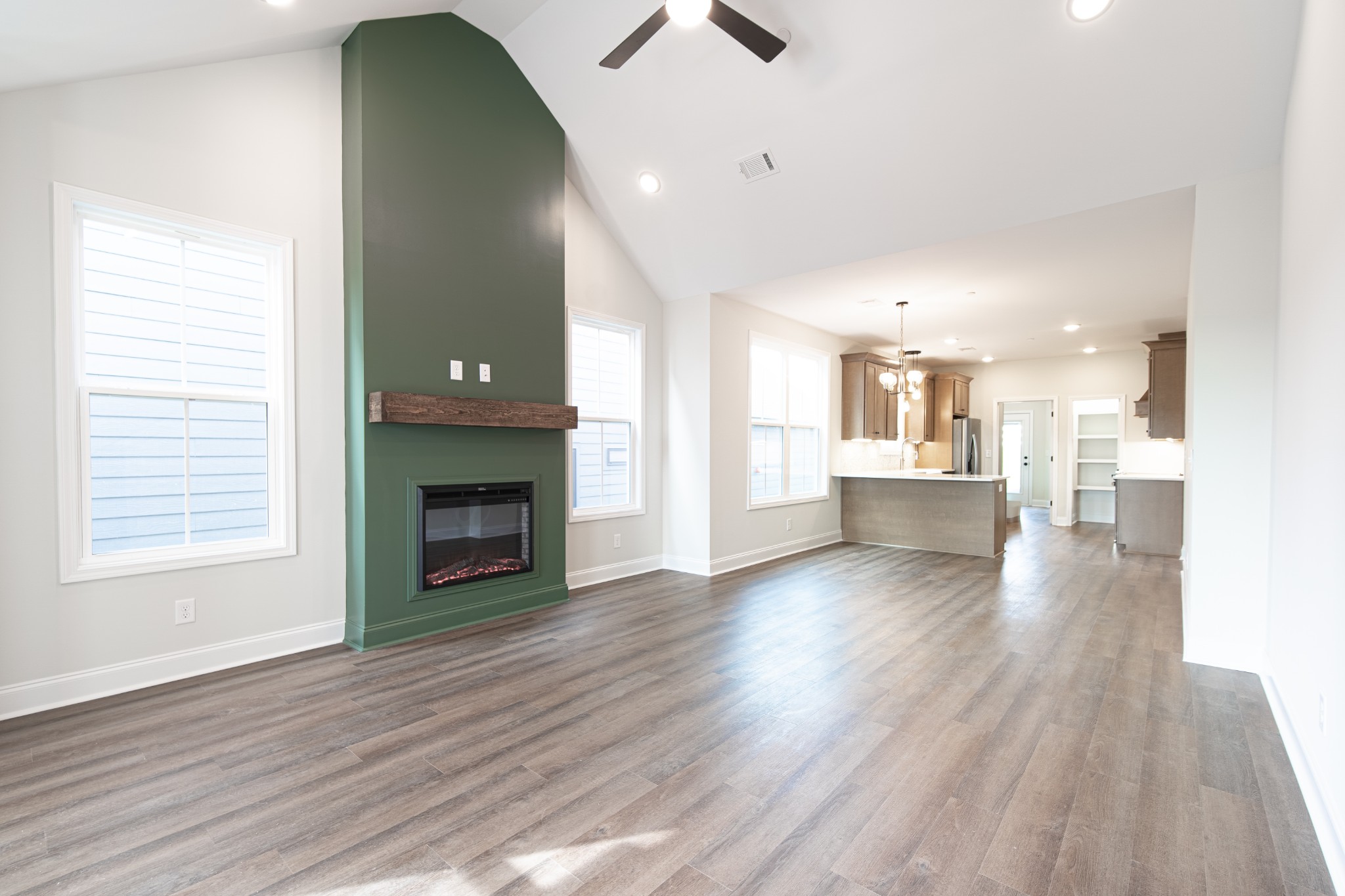 244 Franklin Street Pleasant View, TN 37146 - Photo 4 of 35 an empty room with wooden floor a fireplace and windows