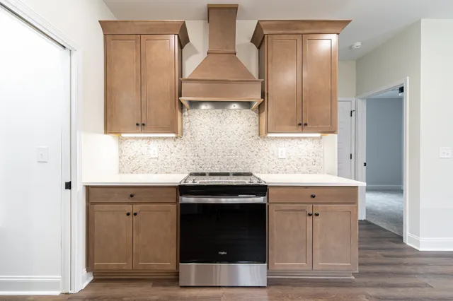 a kitchen with stainless steel appliances granite countertop a stove and a refrigerator