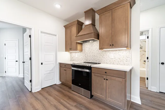 a kitchen with stainless steel appliances granite countertop a stove and a refrigerator
