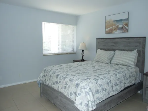a bedroom with bed and window