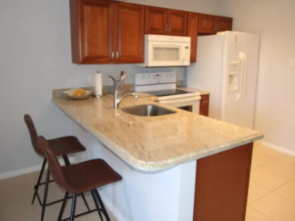 a kitchen with a table chairs and a refrigerator