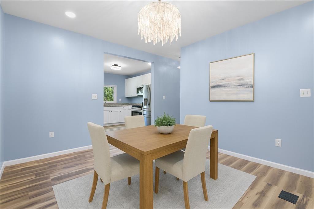 1105 Stock Street Pittsburgh, PA 15207 - Photo 11 of 37 a view of a dining room with furniture and wooden floor