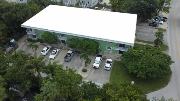 an aerial view of a house with garden space and street view