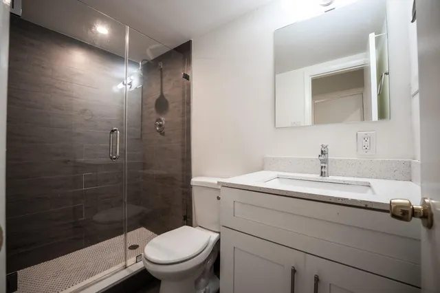 a bathroom with a glass shower door