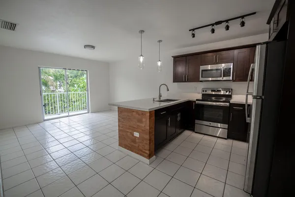 a kitchen with stainless steel appliances granite countertop a sink and a stove