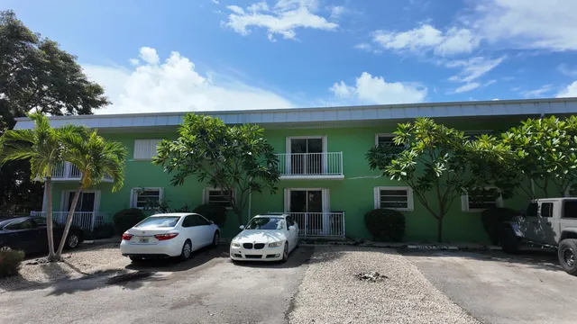 a backyard of a house with lots of green space and fountain