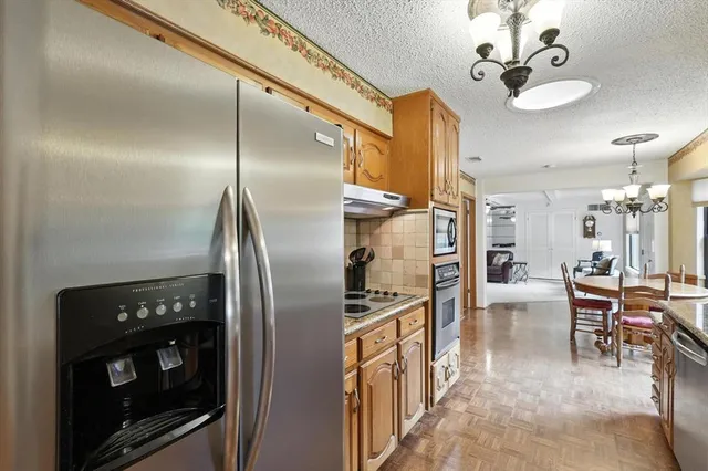 a kitchen with stainless steel appliances granite countertop a sink and stove