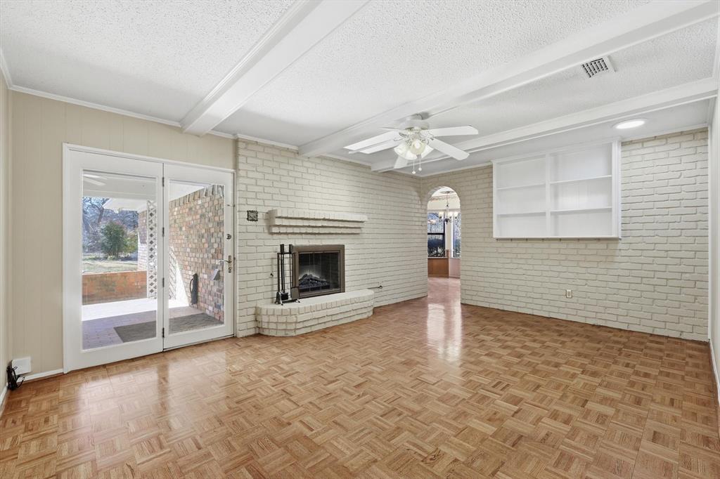 503 Summit Ridge Drive Euless, TX 76039 - Photo 12 of 38 a view of a livingroom with a fireplace a ceiling fan and windows