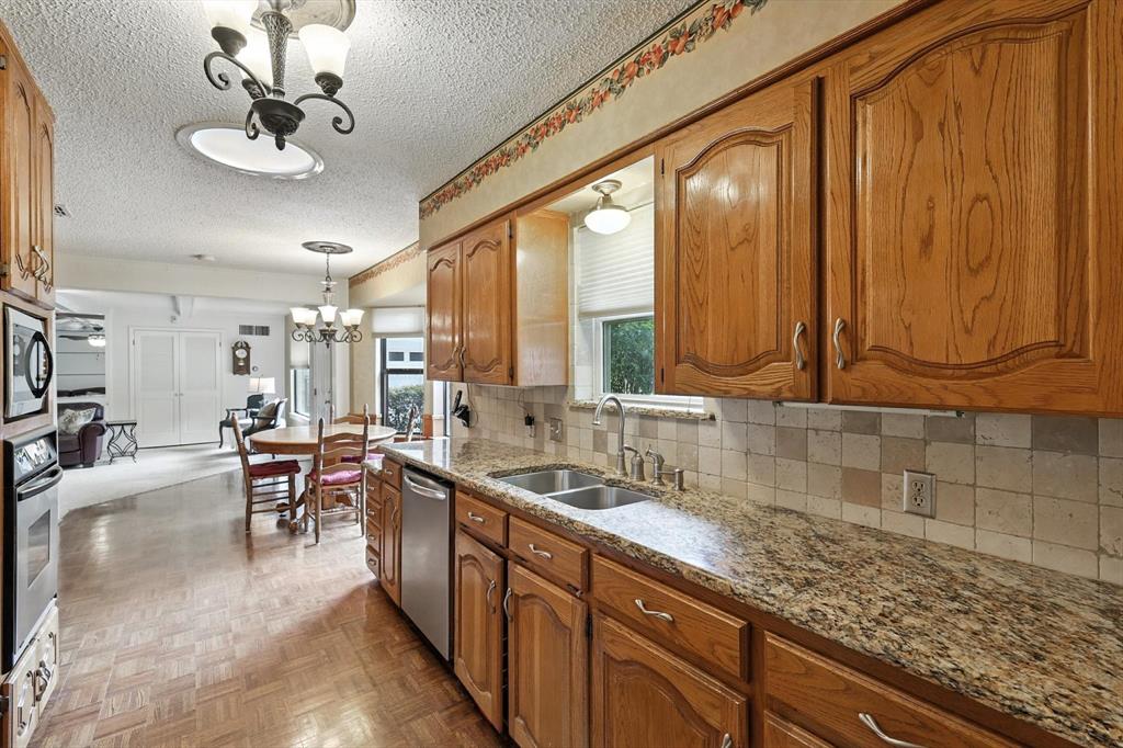 503 Summit Ridge Drive Euless, TX 76039 - Photo 13 of 38 a kitchen with stainless steel appliances granite countertop sink stove and cabinets
