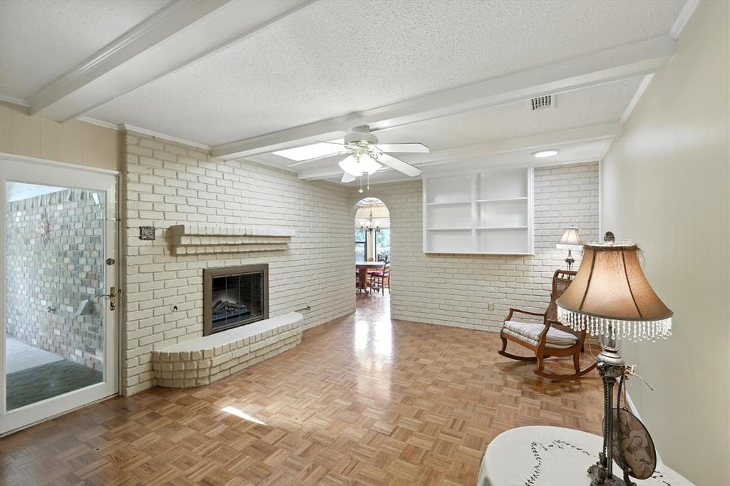 503 Summit Ridge Drive Euless, TX 76039 - Photo 20 of 40 a living room with furniture a fireplace and a chandelier