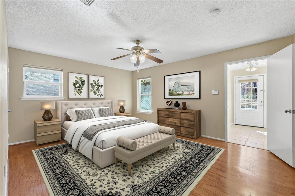 503 Summit Ridge Drive Euless, TX 76039 - Photo 22 of 38 a bedroom with a large bed and a chandelier