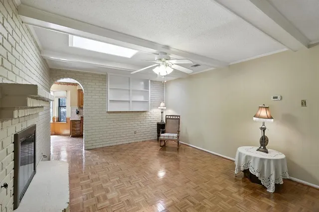a view of a livingroom with furniture wooden floor and a ceiling fan