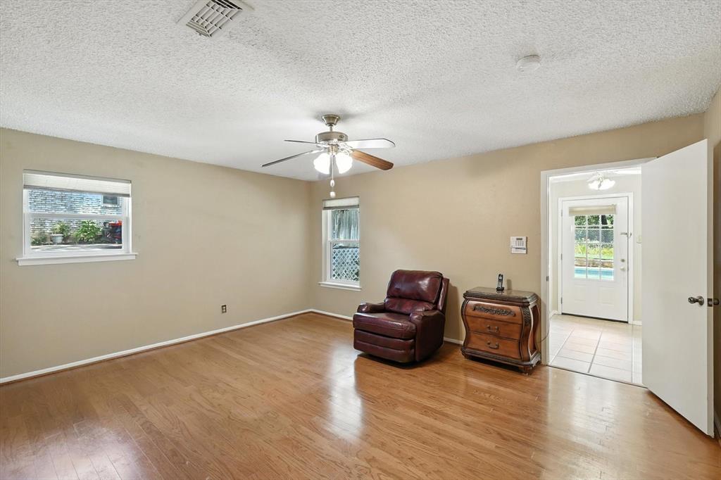 503 Summit Ridge Drive Euless, TX 76039 - Photo 24 of 40 a view of a livingroom with furniture wooden floor and a ceiling fan