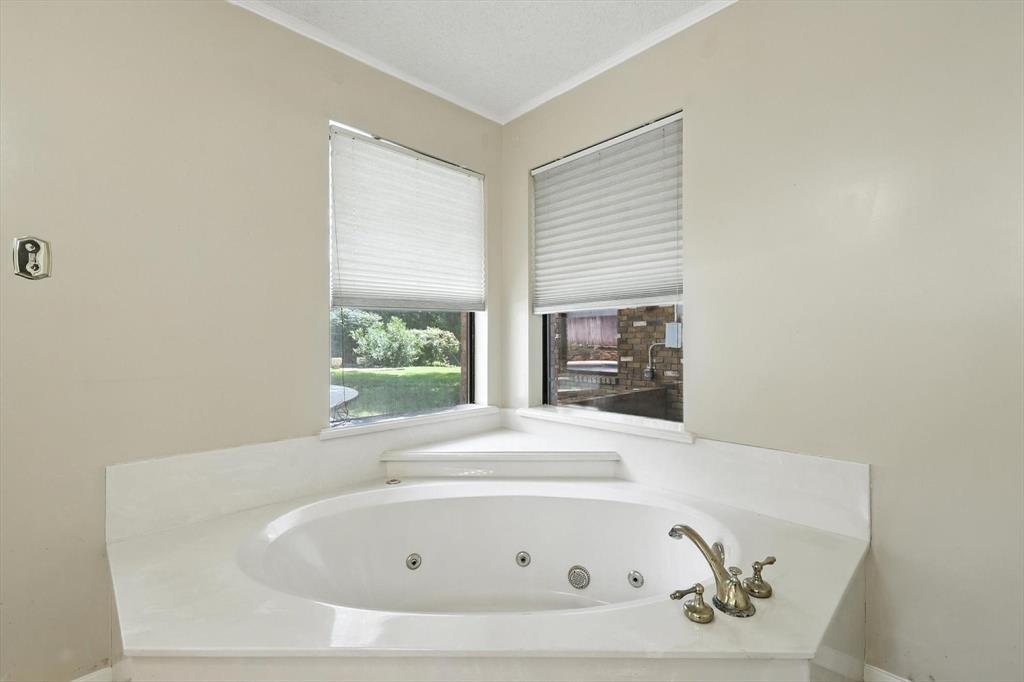 503 Summit Ridge Drive Euless, TX 76039 - Photo 25 of 38 a bathroom with a tub and window