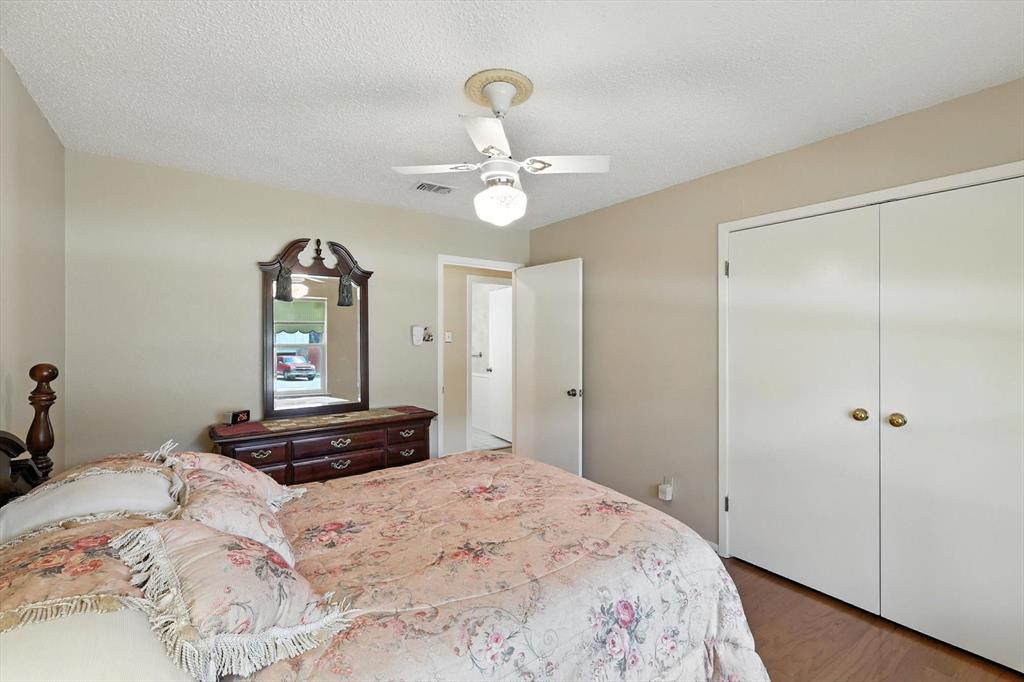 503 Summit Ridge Drive Euless, TX 76039 - Photo 29 of 40 a bedroom with a bed and a chandelier