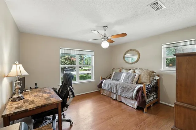 a livingroom with workspace and a couch