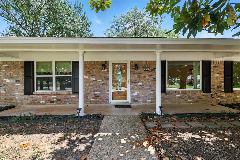503 Summit Ridge Drive Euless, TX 76039 - Photo 4 of 40 a front view of a house with a large window and plants