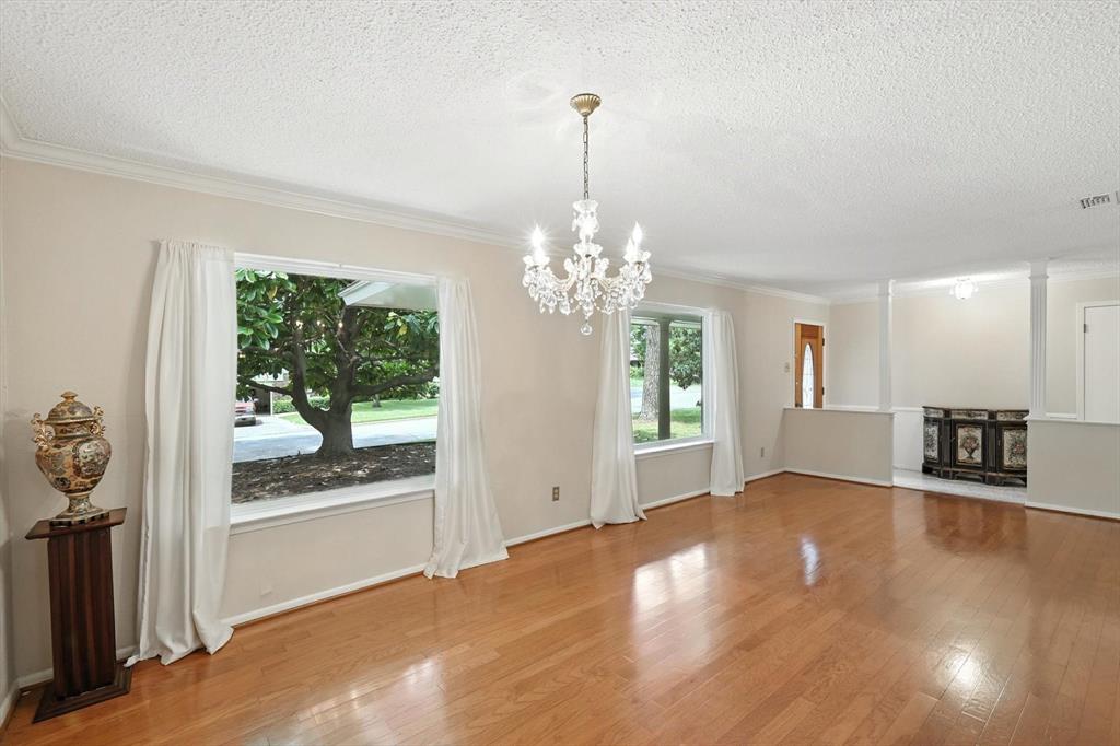 503 Summit Ridge Drive Euless, TX 76039 - Photo 8 of 40 a view of an empty room with window and hardwood floor
