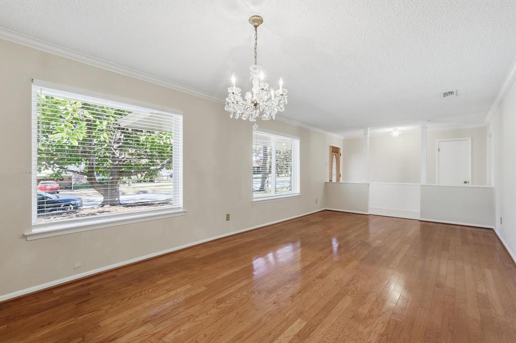 503 Summit Ridge Drive Euless, TX 76039 - Photo 9 of 38 a view of an empty room with wooden floor and a window