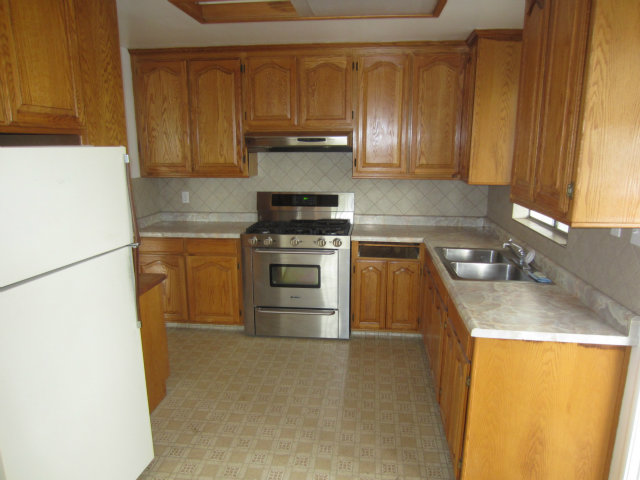 20 Heiner Road Watsonville, CA 95076 - Photo 4 of 25 a kitchen with a sink a stove and a refrigerator