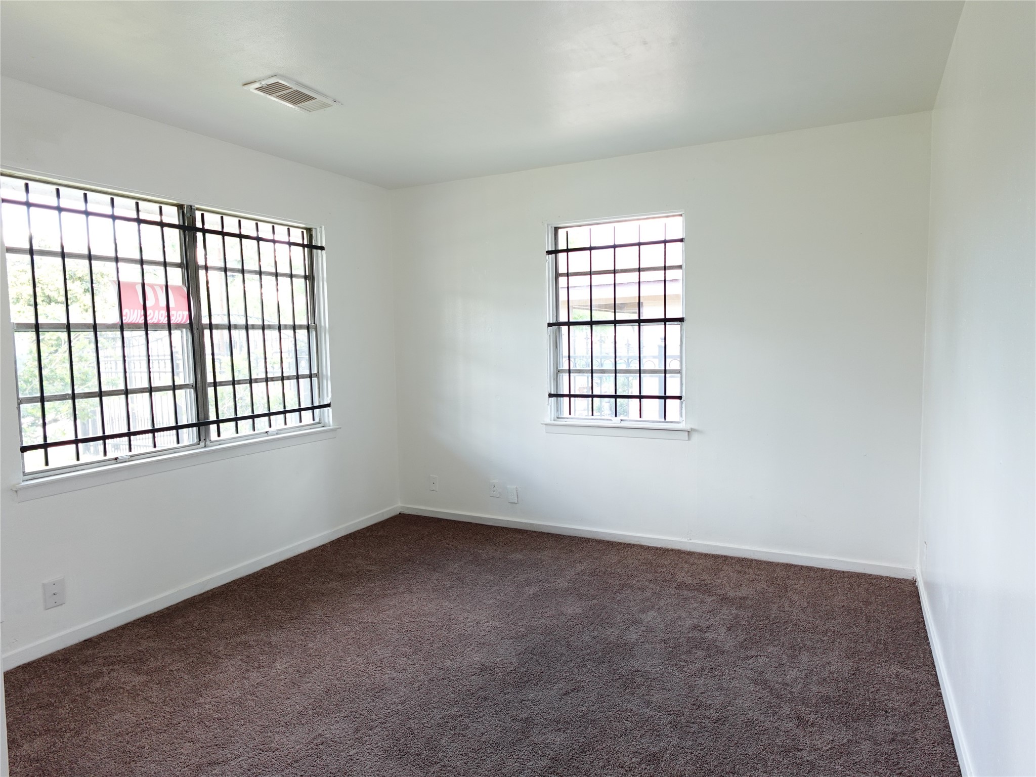 8022 Woodlyn Road Houston, TX 77028 - Photo 7 of 7 an empty room with windows