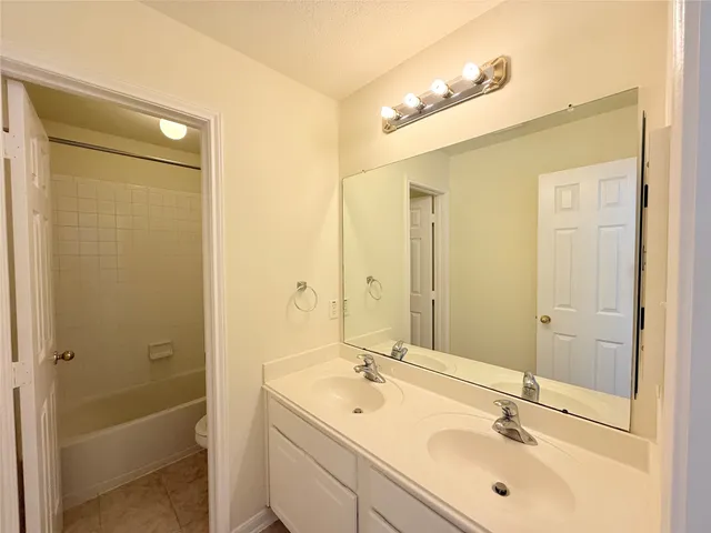 a bathroom with a sink a shower and a mirror
