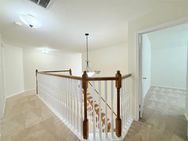 a view of a hallway with staircase